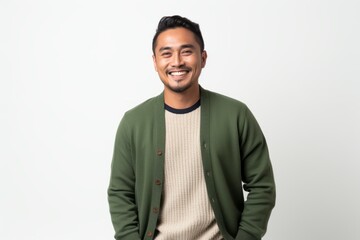 Lifestyle portrait of a Indonesian man in his 30s in a white background wearing a chic cardigan