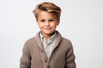 Portrait of a cute little boy in a gray coat on a white background