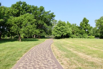 The empty pathway in the park on a sunny day.