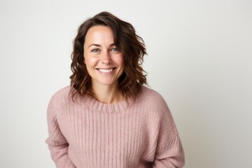 Fototapeta premium Group portrait of a Russian woman in her 30s in a white background wearing a cozy sweater