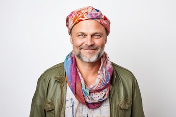 Lifestyle portrait of a Russian man in his 40s in a white background wearing a foulard