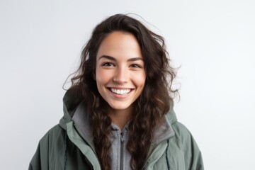 Fototapeta premium Portrait of a smiling young woman in winter jacket over white background