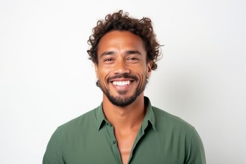 Medium shot portrait of a Brazilian man in his 30s in a white background wearing a chic cardigan