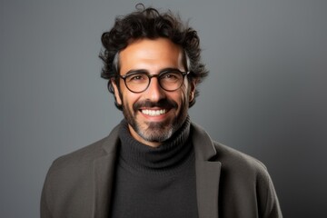 Fototapeta premium Portrait of a handsome young man smiling at the camera while wearing glasses