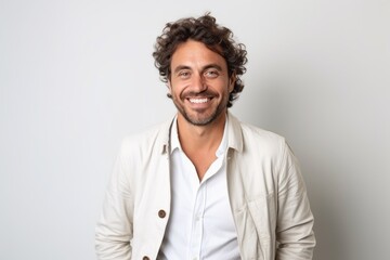 Obraz premium Portrait of a handsome man with curly hair smiling at camera.