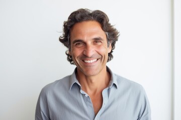 Fototapeta premium Medium shot portrait of a Brazilian man in his 40s in a white background wearing a chic cardigan