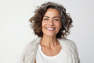 Portrait of a happy mature woman smiling and looking away over white background