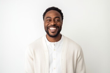 Medium shot portrait of a Nigerian man in his 30s in a white background wearing a chic cardigan