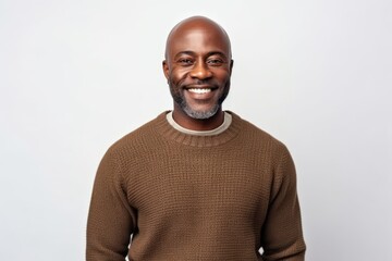 Obraz premium Medium shot portrait of a Nigerian man in his 40s in a white background wearing a cozy sweater