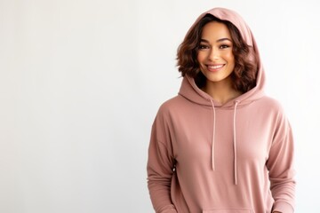 Portrait of a beautiful woman in a pink hoodie on a white background