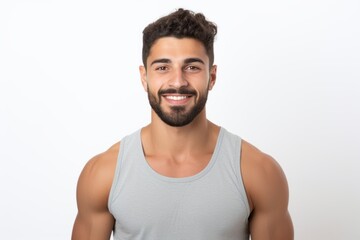 Obraz premium Portrait of a handsome young man smiling at the camera while standing against white background