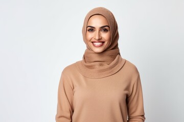 Portrait of a beautiful muslim woman in hijab smiling at camera