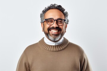 Obraz premium Portrait of a smiling middle-aged Indian man wearing glasses and a brown sweater