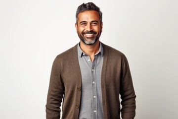 Portrait of a happy indian man smiling at camera over white background