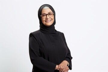 Portrait of a smiling mature muslim woman wearing hijab and glasses