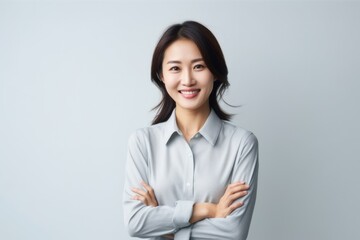 Portrait of a smiling asian businesswoman standing with crossed arms
