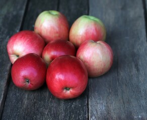 Close-up of red apples on the background of an old board.