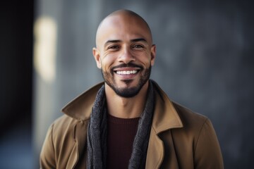Obraz premium portrait of smiling african american man in coat and scarf