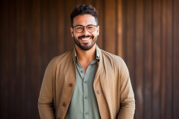 Portrait of a handsome young man with eyeglasses on wooden background
