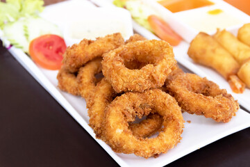 Salt and pepper squid deep-fried or Calamari on a white plate.