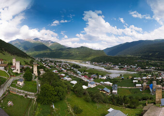 Fototapeta na wymiar A large wide panorama aerial view of Mestia town in Svaneti region of Georgia, located in the Caucasus Mountains. The townlet is dominated by stone defensive towers Mestia