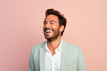 Fototapeta premium Group portrait of a Brazilian man in his 30s in a pastel or soft colors background wearing a chic cardigan
