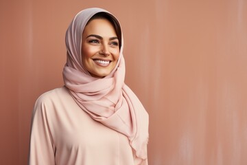 Portrait of a beautiful young muslim woman with hijab smiling.