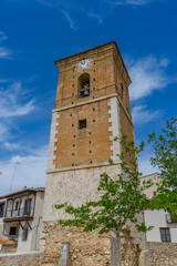 Fototapeta na wymiar Spanish church tower, capturing Chinchón's religious heritage, intricate clock face and ancient bell in view