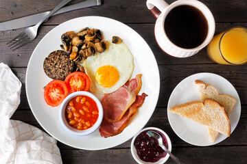 Full Scottish breakfast with haggis. Overhead view table scene on a dark wood background.