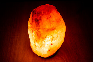 Salt lamp on. Salt ceiling in the dark, natural mineral lamp.Salt cover, lamp on.