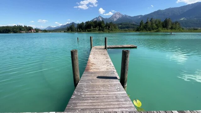 beautiful jetty among reed at Faaker See lake in Carinthia, Austria