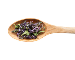 Dried green Peppermint (Mentha piperita) blossoms on wooden spoon, herbal tea ingredient, isolated...