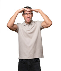 Astonished young man with a gesture of looking far