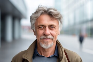 Portrait of a senior man with grey hair in a urban environment
