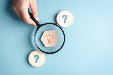 Magnifier focus to Light Bulb which among Question icon. Target solution target, successful business and thinking solution strategy concept.