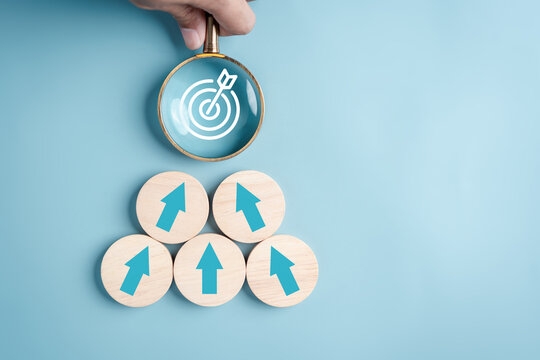 Business growth success achievement concept, arranging wooden block stacking with magnifier focus to target as step stair or ladder for planning customer group development concept.