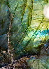 This is a macro photo of a colorful blue and green labradorite stone.  I used special lighting to bring out the iridescent colors and cracked mineral textures.