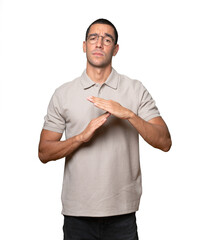 Stressed young man making a time out gesture with his hands