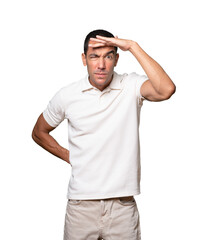 Fototapeta premium Concentrated young man with a gesture of looking far