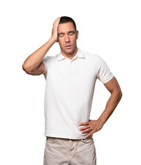 Depressed young man posing against background