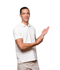Friendly young man making a gesture of welcome