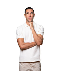 Serious young man looking against background