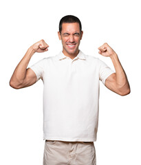 Fototapeta premium Proud young man doing a gesture of strength with his arm