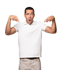 Fototapeta premium Surprised young man pointing down