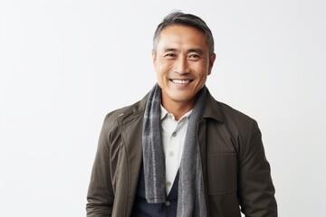 Portrait of happy mature asian man in casual clothes, smiling at camera, standing over white background.