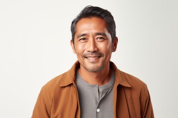 Portrait of a smiling asian man looking at camera isolated on white background