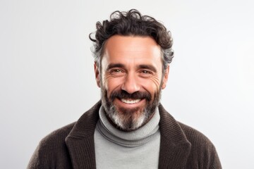 Obraz premium Portrait of a smiling middle-aged man in a sweater and scarf on a white background