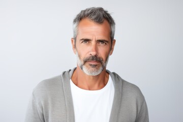 Obraz premium Portrait of mature man with grey hair looking at camera isolated on white background