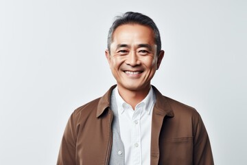 Portrait of a smiling mature Asian man in brown jacket looking at camera