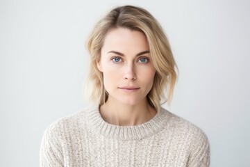 Portrait of a beautiful young woman looking at camera over white background